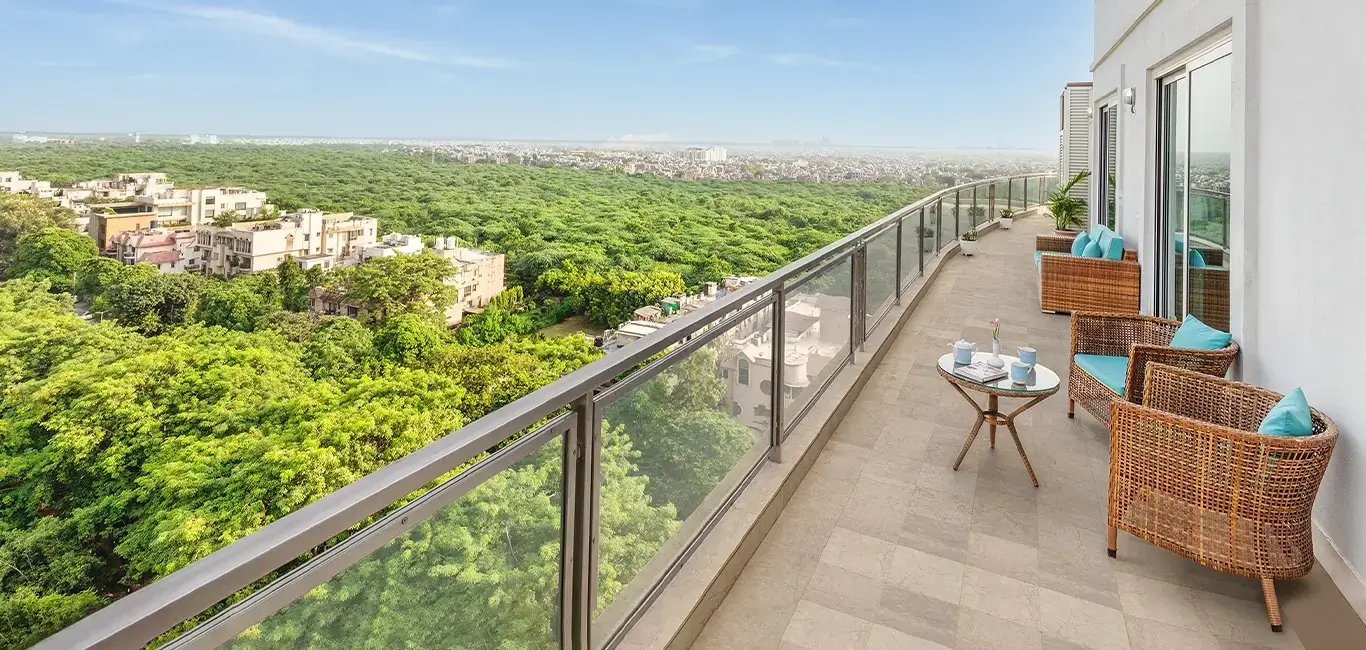 Scenic balcony view with natural beauty of the surroundings, lush greenery, fresh air, and open skies.