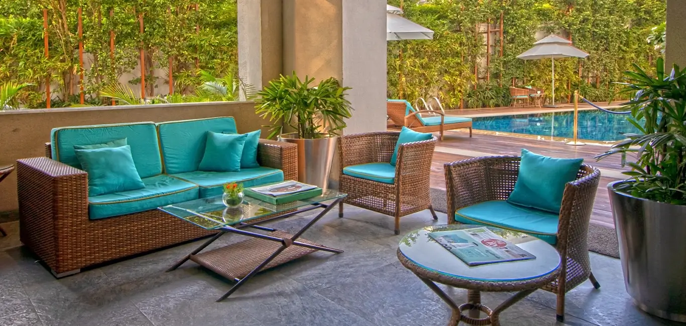 Seating area with pool view for morning breakfast or relaxation in DLF king's court luxury apartments.